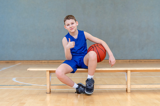 School kid playing basketball in a physical education lesson. Horizontal sport theme poster, greeting cards, headers, website and app