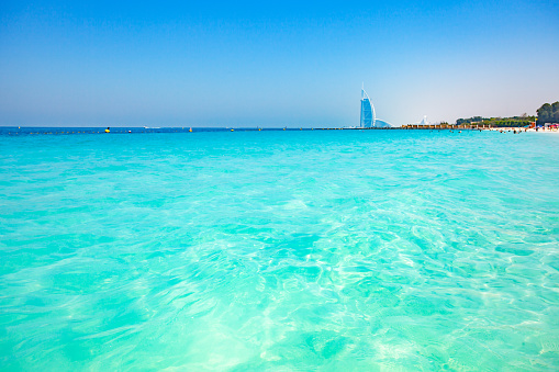 Dubai, UAE  april 06, 2023: Sufouh Beach turquoise transparent water in sea and Burj Al Arab