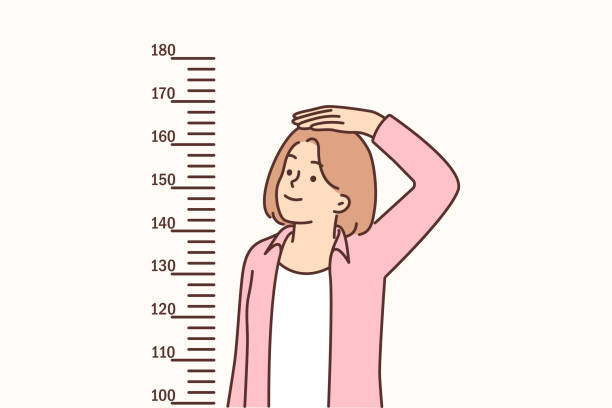 십대 소녀는 키가 커지고 싶어 벽에 있는 자국 근처에 서서 키를 측정한다 - tall human height women measuring stock illustrations