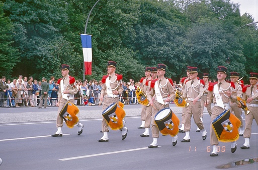 Tiergarten, Berlin (West), Germany, 1987. French military band at an Allied Forces parade in Berlin's Tiergarten. Also: spectators.