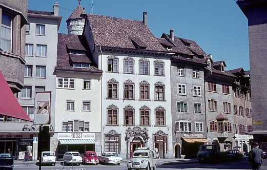 Schaffhausen, Switzerland, 1964. Row of houses in Schaffhausen. Furthermore: vehicles, shops and locals.