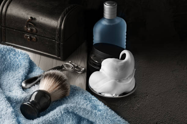 Shaving accessories with shaving foam, razor, shaving brush, lotion on black background mockup