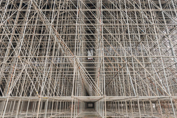 Vertical scaffolding formed a myriad of grid. Industrial and modern urban construction background.