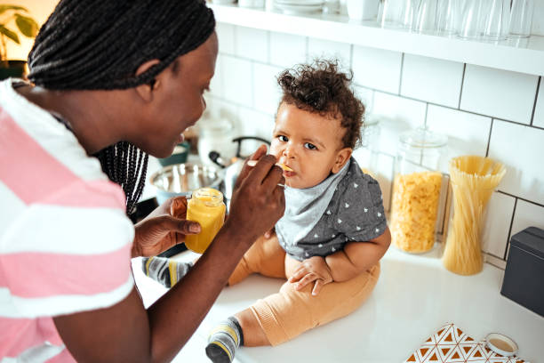 istock Mother feeds her baby 1487581280
