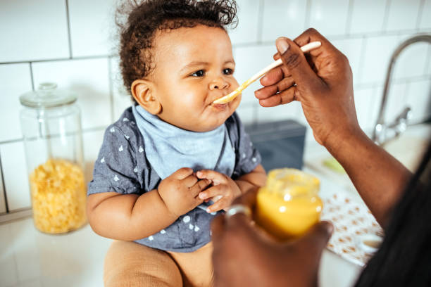 istock Mother feeds her baby 1487581402