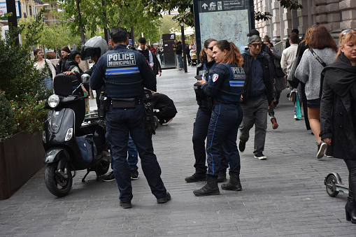 French Municipal Police Officers Standing, Talking To People, Retail Store, Building Exterior, People Walking Scene In Nice French Riviera France Europe