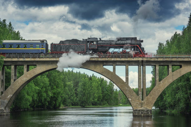 istock Retro steam train moves above the river. 1487586372