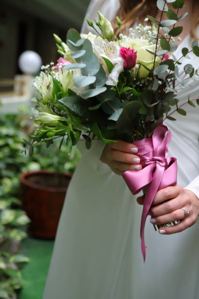 istock Wedding bride bouquet, elegant flowers in bride hands 1487587776