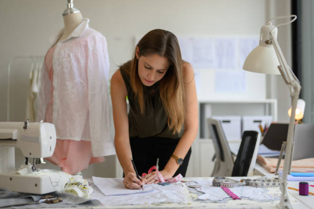 istock Beautiful woman dressmaker working in workshop studio 1487588479