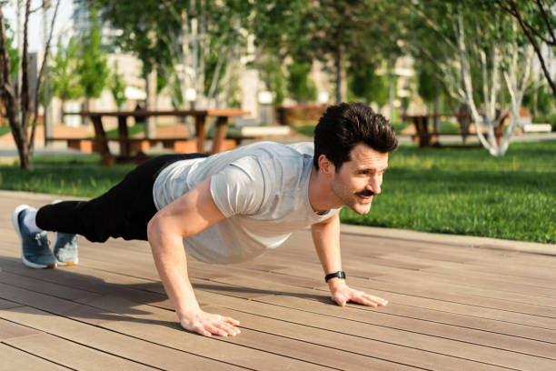 istock Happy young man is exercising outdoors 1487589695