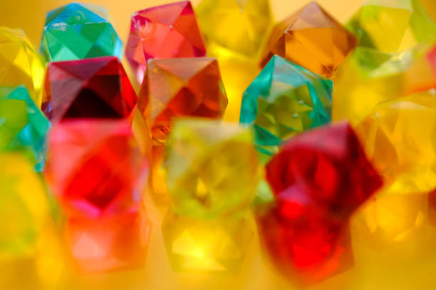 Multicolored crystal background. Blurred, defocused bright gems.