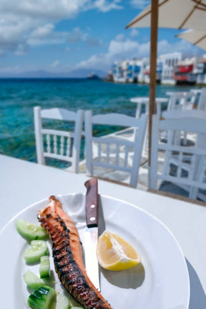 Grilled octopus legs on the table on the beach in Mykonos, one of the Greek islands.