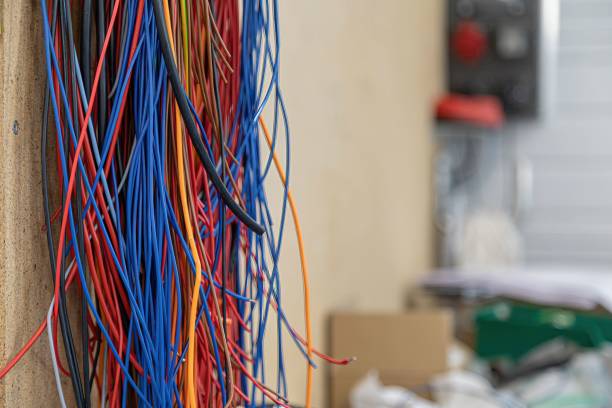 istock multicolored electric wires hanging on a wall 1487593538