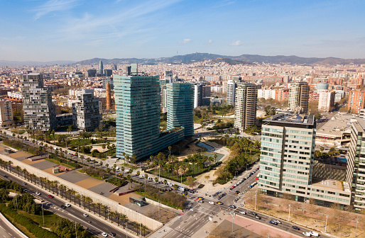 Aerial view of new residential complex of Diagonal Mar i el Front Maritim del Poblenou in sunny day, Barcelona, Spain