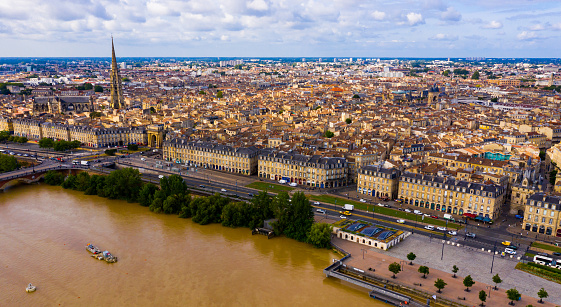 View from drone of modern cityscape of French port city of Bordeaux on river Garonne in summer