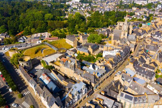 Drone view of Guingamp with Basilica and castle walls, France Scenic drone view of summer cityscape of Guingamp with Gothic Basilica of Notre Dame de Bon Secours and medieval castle walls, France guingamp brittany stock pictures, royalty-free photos & images