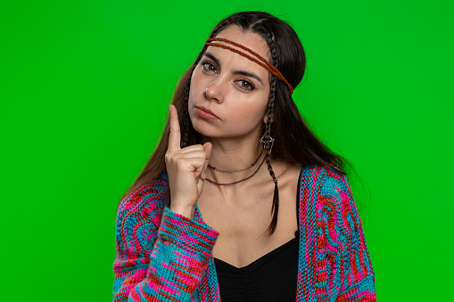 Quarrel. Displeased young woman gesturing hands with irritation and displeasure, blaming scolding for failure, asking why this happened. Hippie girl isolated on chroma key background, green screen
