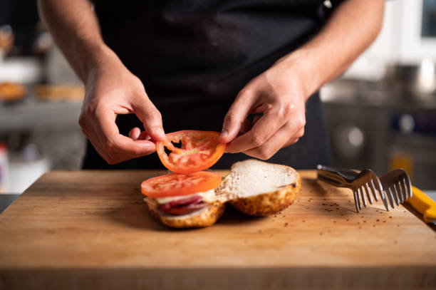 istock A male chef prepares a sausage and cheese sandwich 1487596709