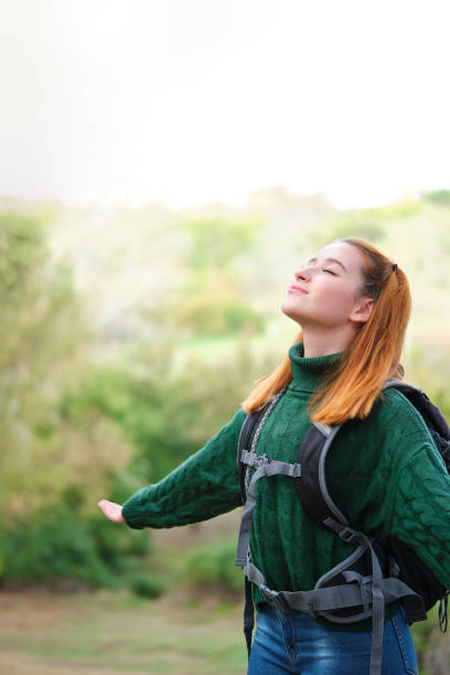 istock Backpacker woman in the mountain breathing fresh air. 1487605579