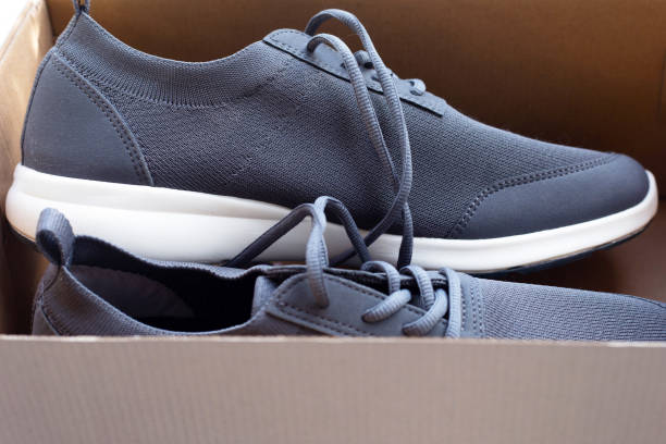 istock Sneakers in brown cardboard shoes box 1487605983