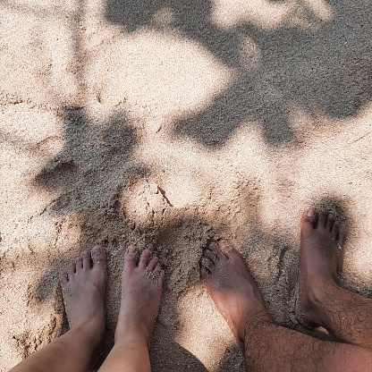 a couple on vacation on an Indonesian beach, they captured the moment by taking a photo of their feet