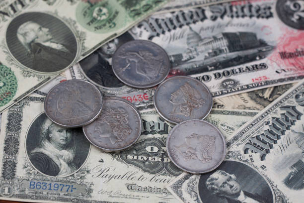 istock Old US banknotes and silver certificates with silver dollar coins 1487610354