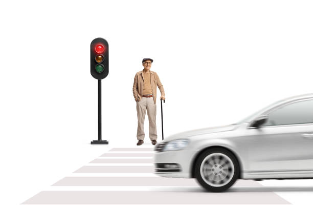 istock Elderly gentleman standing with a cane at traffic lights 1487619703