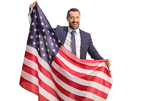 Happy young professional man holding a USA flag isolated on white background