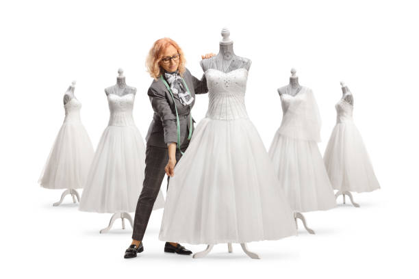 istock Seamstress measuring a bridal gown on a mannequin doll 1487620789