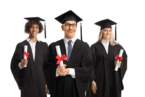Elderly man and graduate students in gowns holding diplomas isolated on white background