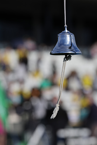 Close up of the bell at the track events. The bell is rung to signal the last lap in the track events.