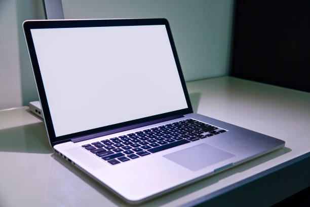 istock Laptop closeup on glass table 1487625296