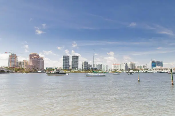 Glistening Water & Boats on the Waterfront Inlet in Front of Downtown West Palm Beach, Florida Under a Bright Blue Sky in March of 2023 During Springbreak & the Annual Boat Show at Midday on a Bright Sunny Spring Day