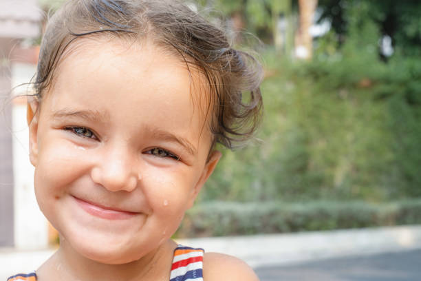 A portrait of a cute little Caucasian kid outdoors.