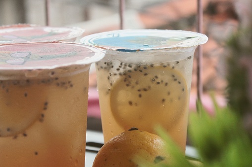 Close Up of Fresh Lemon Iced Tea with basil seeds in a plastic cup