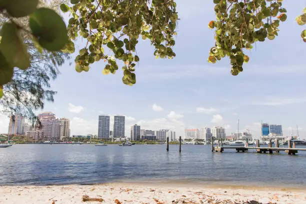 Glistening Water & Boats on the Waterfront Inlet in Front of Downtown West Palm Beach, Florida Under a Bright Blue Sky in March of 2023 During Springbreak & the Annual Boat Show at Midday on a Bright Sunny Spring Day