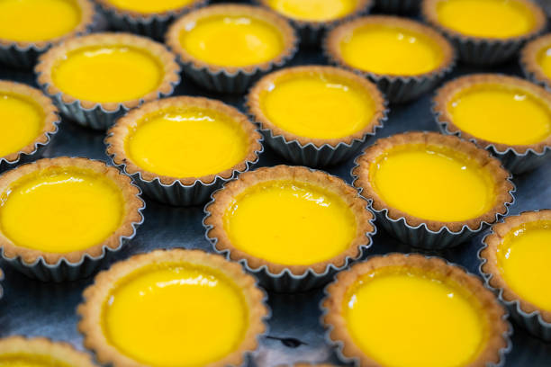 Freshly baked egg tarts from local food shop. A famous traditional snack for morning breakfast and afternoon tea. stock photo