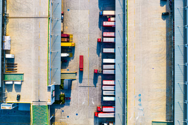 istock Aerial view of trucks loading at logistic center 1487638054