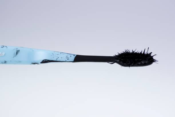 istock Toothbrush still life plastic toothbrush covered in moss and paint 1487638837