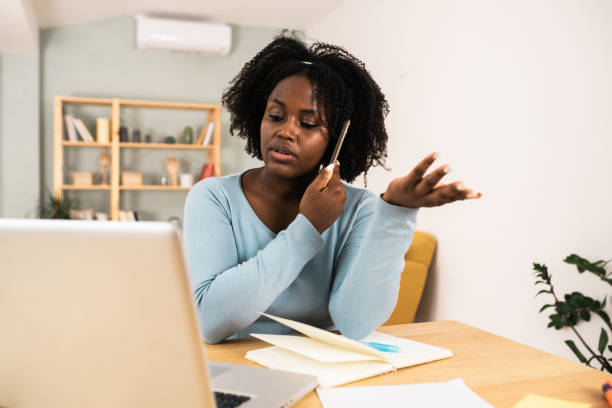 istock Beautiful African American economist working from home 1487640814