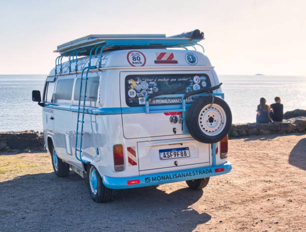 colonia del sacramento, uruguay - november 1 2022: a volkswagen van or bus parked at cost with sea or ocean view