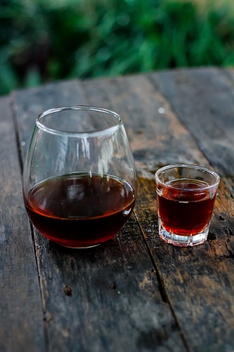 Manual brew v60 coffee in a glass on a wooden background