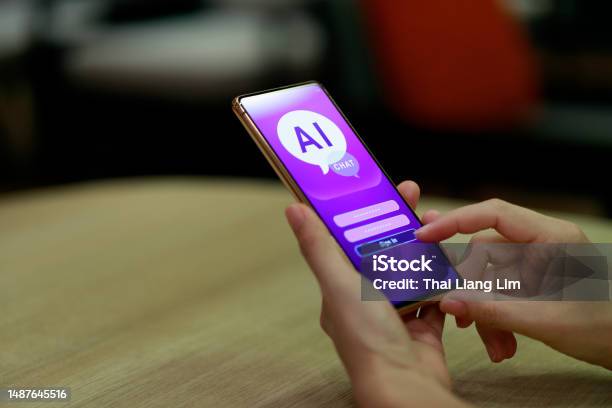 A Woman Is Using Her Mobile Phone To Log In And Chat With An Artificial Intelligence Chatbot This Application Represents A Global Connection And The Latest Innovation In Ai Technology Stock Photo - Download Image Now
