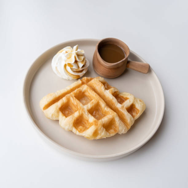 istock waffles with ice cream and chocolate syrup on white  background 1487648695