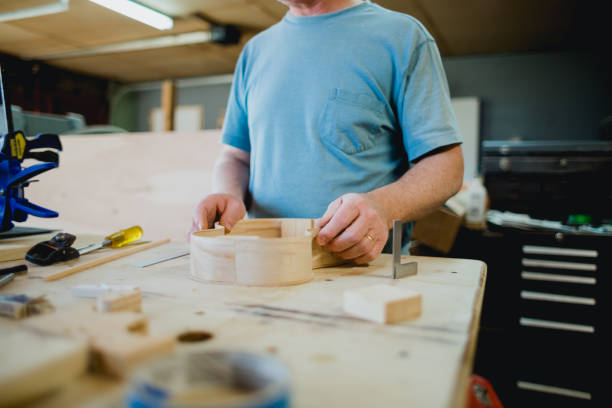 istock Builders Hands in Wood Working Shop 1487654338