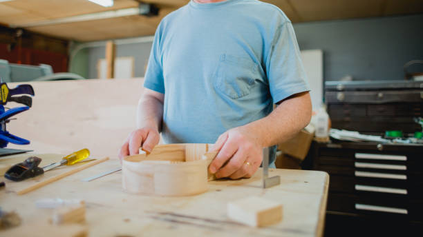 istock Builders Hands in Wood Working Shop 1487654339