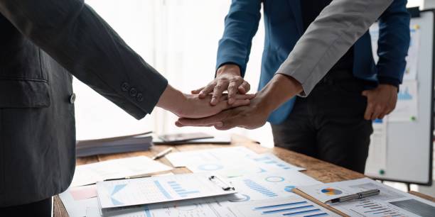 istock Business teamwork join hands together. group of young people putting their hands. Teamwork Join Hands Support Together Concept. 1487655456