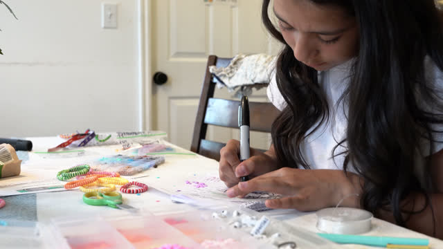 A 12-14 Year Old Girl Inside Her Home is Making Bracelets To Sell to Raise Funds