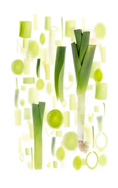 Abstract background made of Leek vegetable pieces, slices and leaves isolated on white.