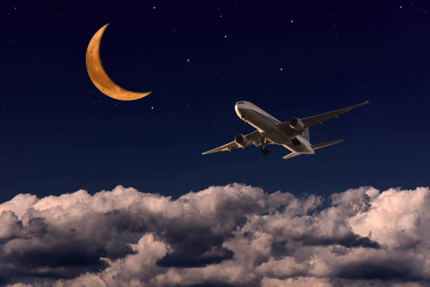 istock Airplane passing the strawberry crescent moon 1487661472